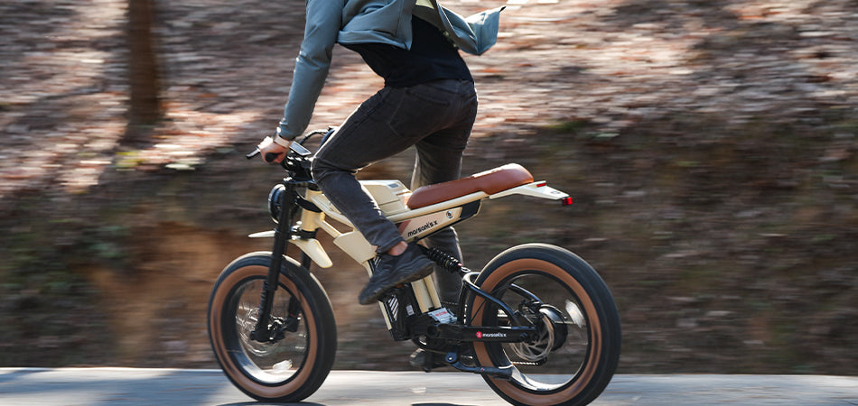 A person riding a modern electric bicycle on a forest path.